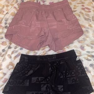 adidas Women's Pacer Woven Deboss Shorts. Mauve pink. And black pair.